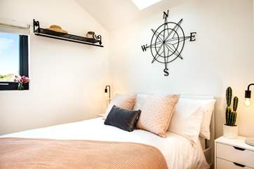 The bedroom is delightful, decorated with soft tones.