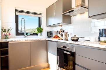 The kitchen is both stylish and well-equipped.
