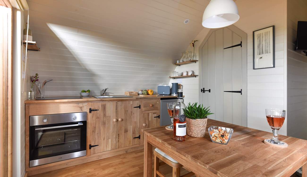 There's a well-equipped kitchen area and delightful dining area within the open place living space.
