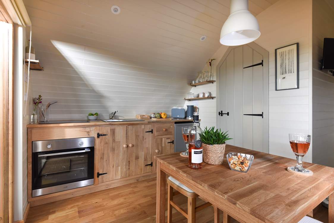 There's a well-equipped kitchen area and delightful dining area within the open place living space.