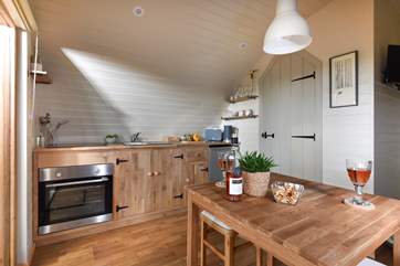 There's a well-equipped kitchen area and delightful dining area within the open place living space.
