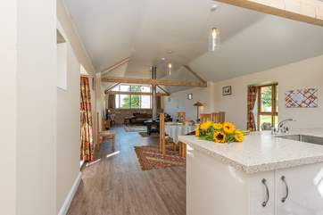 The bright open plan living-space has the double-sided wood-burning stove as a real feature.