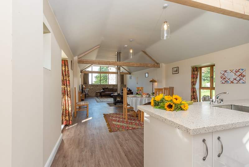 The bright open plan living-space has the double-sided wood-burning stove as a real feature.