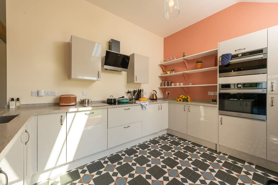 The kitchen is bright and cheerful, and equipped with all that you could possibly want for your stay here.