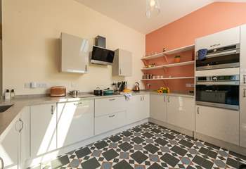 The kitchen is bright and cheerful, and equipped with all that you could possibly want for your stay here.