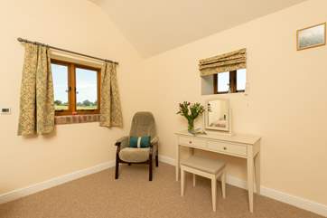 The master bedroom is very spacious and looks out over the fields next to the barn.