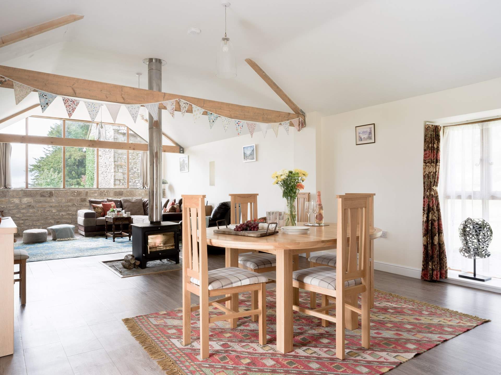 The open plan living space is wonderful bright place to be, with views out of the huge windows to Glastonbury Tor