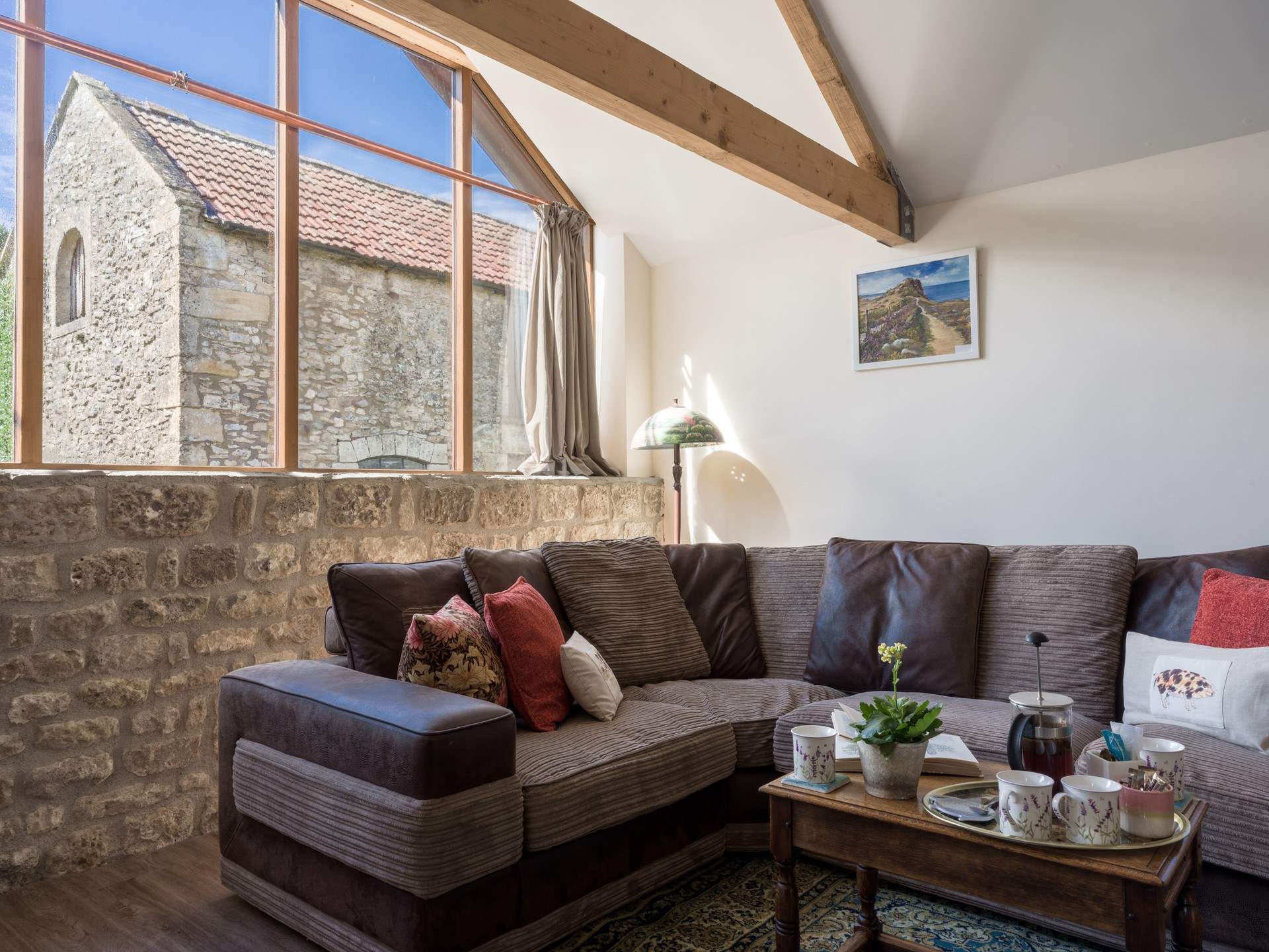 The large, comfy sofa is cleverly positioned to maximise light whilst also being a cosy place to be of an evening