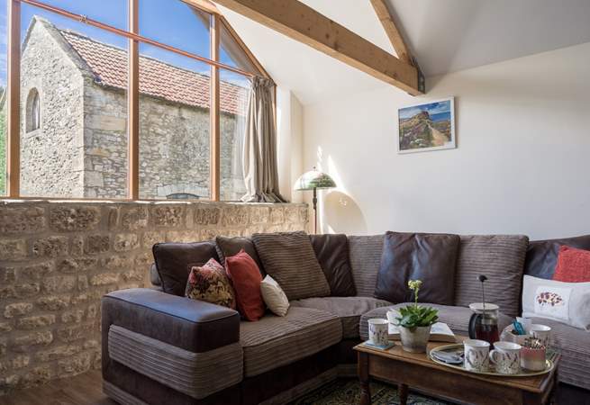 The large, comfy sofa is cleverly positioned to maximise light whilst also being a cosy place to be of an evening