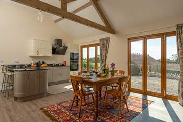 Sunshine fills this wonderful sociable space. The little building beyond the stone wall is a store room for the owner (you will not be disturbed during your stay). The rooftop lower down is The Piggery.