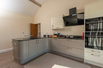 Another view of the slick fitted kitchen. The door in the corner leads into the utility-room.