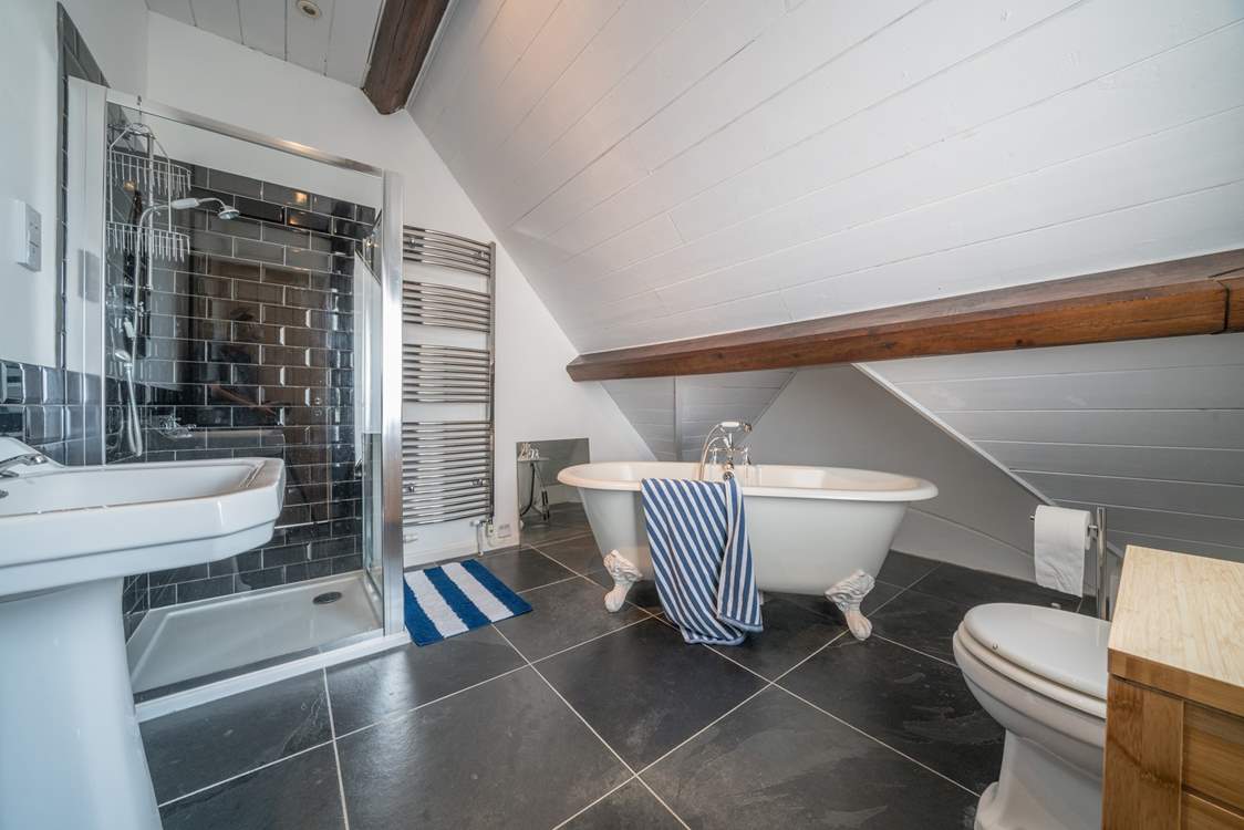 The main bedroom has its own en suite bathroom with roll-top bath.