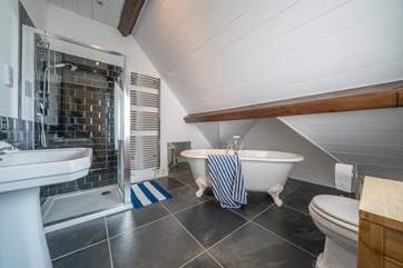 The master bedroom even has its very own en suite bathroom with roll-top bath.