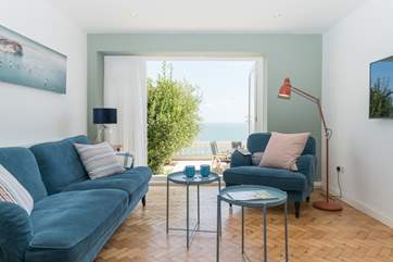 Doors lead out to the patio from the living-room bringing the outdoors in.