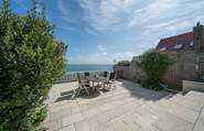 This stunning patio area has the most incredible sea views. Please take care on the patio as the wall is low and the steps that lead down to the lower garden area are steep and uneven.