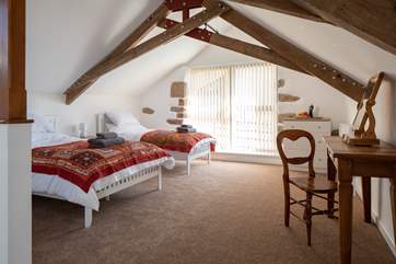 The bedroom offers flexible sleeping arrangements. Whether you wish to snuggle up together or seek your own sleeping space, the flexibility of this room set-up offers both.