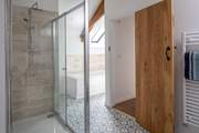 The en suite also boasts a bath to relax in.