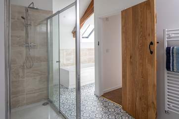 The en suite also boasts a bath to relax in.