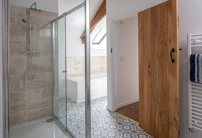 The en suite also boasts a bath to relax in.