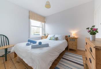 Double bedroom with king-size bed looks out to the stunning sea view.
