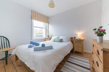 Double bedroom with king-size bed looks out to the stunning sea view.