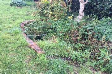 Please note there is a small covered pond in the garden.