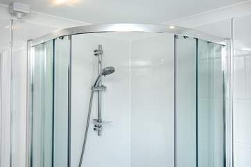 There is a large corner shower.