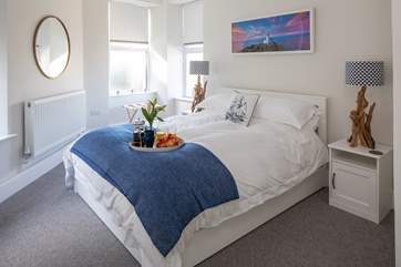 The master bedroom offers this beautiful king-size bed.