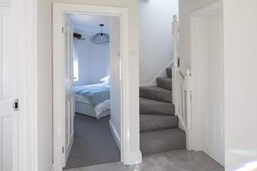 The stairs lead from the entrance hall to the first floor living and balcony area.
