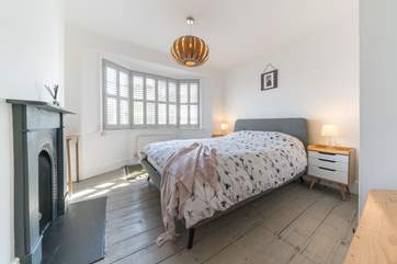 The light filled double bedroom has a king-size bed.