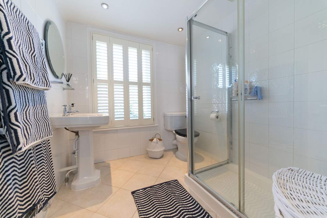 The shared family bathroom has a large shower cubicle.