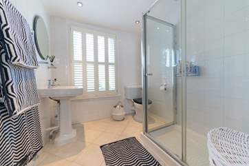 The shared family bathroom has a large shower cubicle.