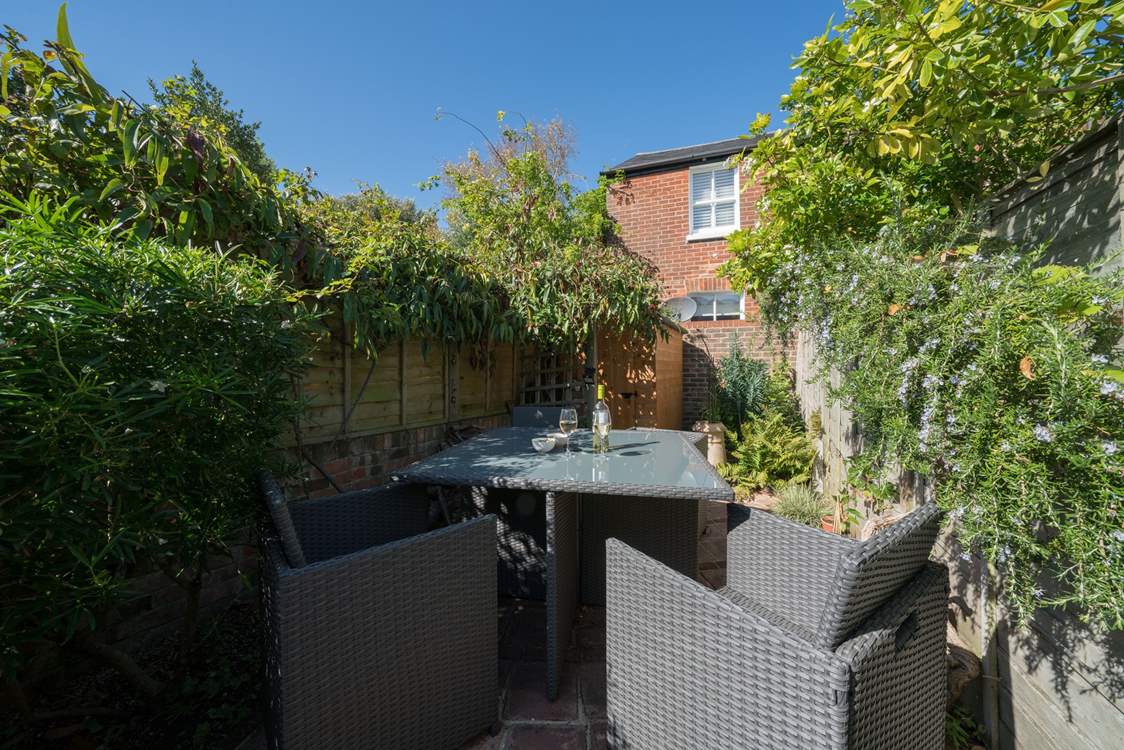 The pretty garden catches the midday sun.