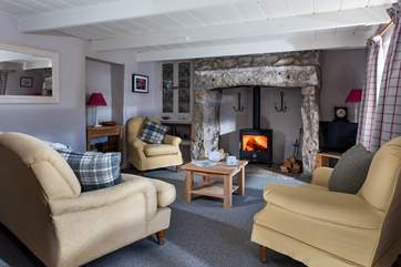 Up a step into the cosy sitting-room with wood-burning stove.