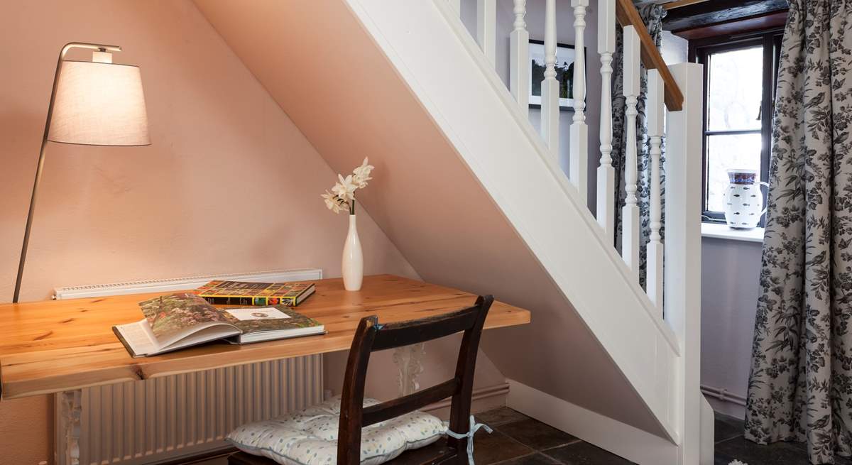 If you need to check in with the outside world, there is a useful desk located conveniently under the stairs.