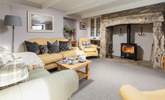 Take a step up into the cosy sitting-room with wood-burning stove and logs are provided for the entirety of your stay. - Thumbnail Image