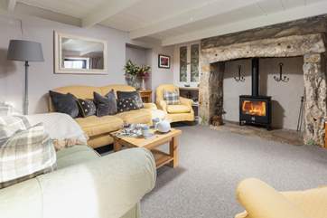 Up a step into the cosy sitting-room with wood-burning stove.