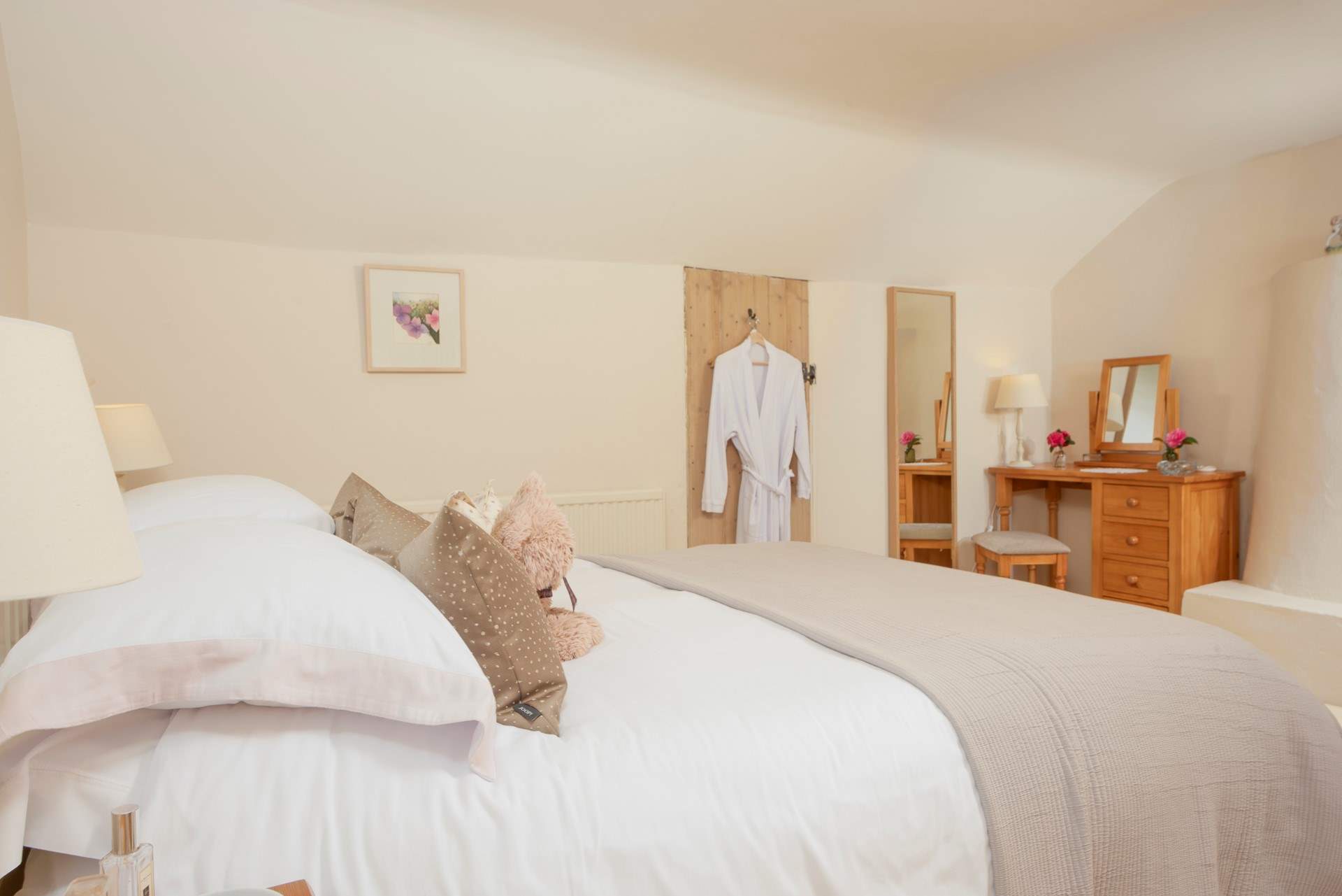 The beautiful main bedroom is fit for a queen, oh and there are waffle gowns for all guests.