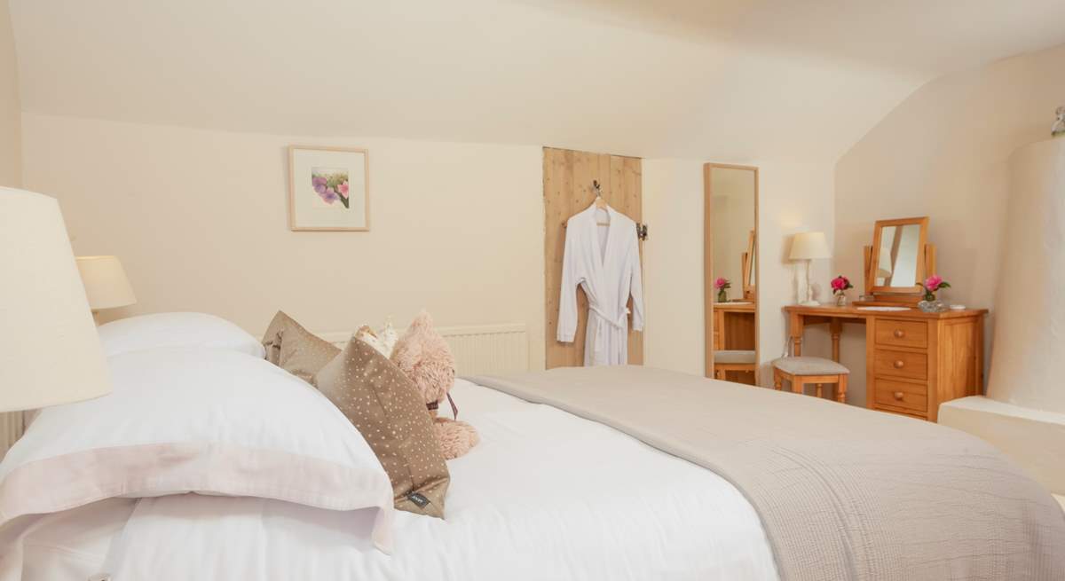 The beautiful main bedroom is fit for a queen, oh and there are waffle gowns for all guests.