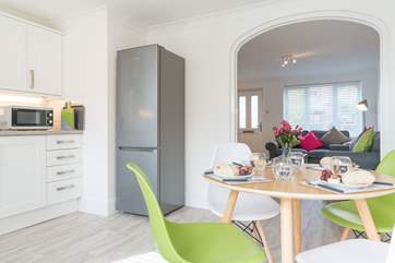 The kitchen looks through into the open plan living area.