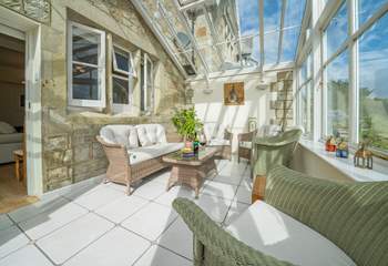 Relax with a glass of wine in this gorgeous conservatory. 