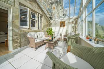 Relax with a glass of wine in this gorgeous conservatory.