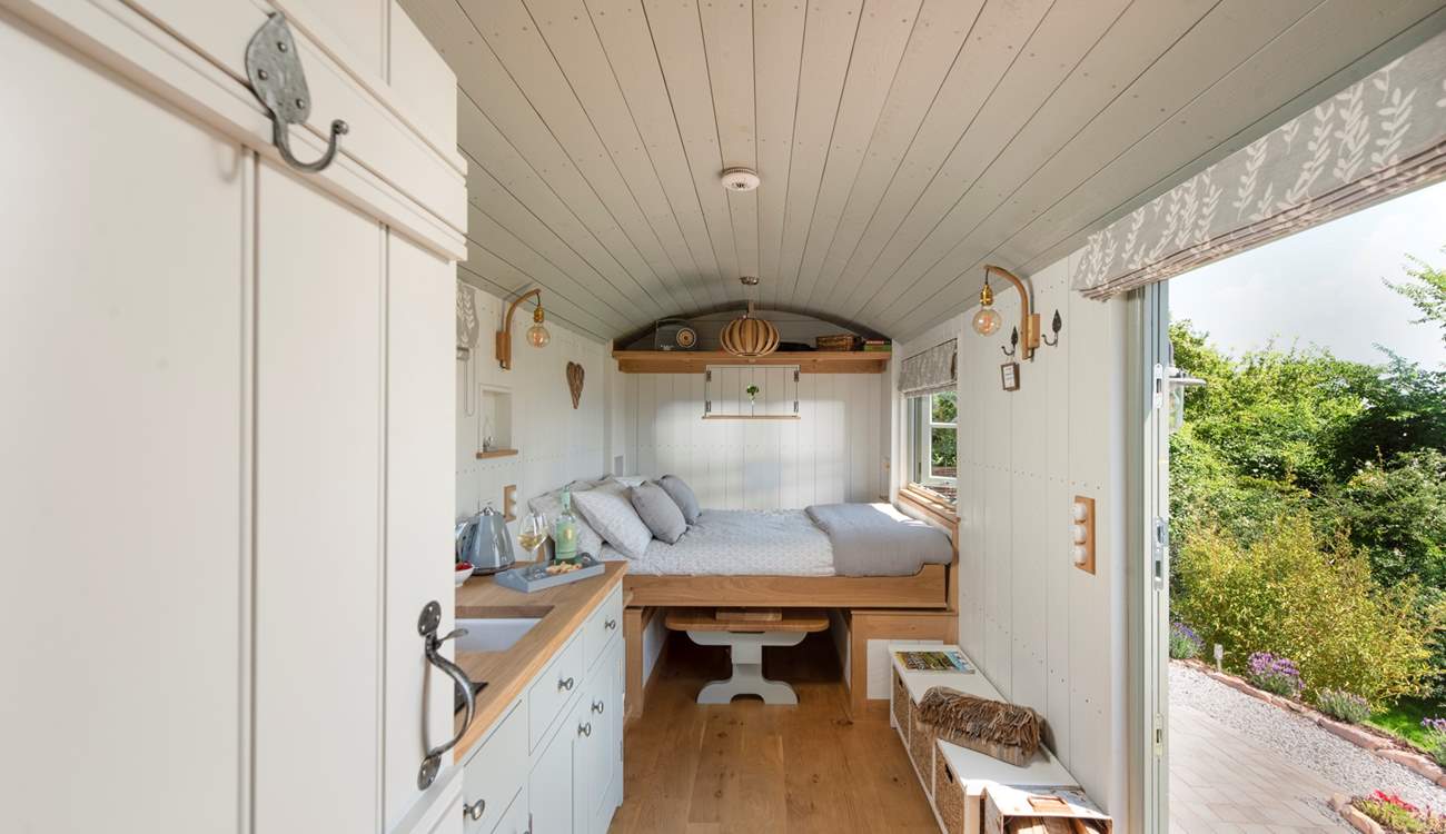 The bed cleverly folds down from the wall to sit atop the dining table. 