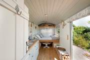 The bed cleverly folds down from the wall to sit atop the dining table.