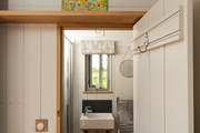 The shower-room sits to the left of the hut.