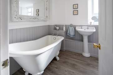 The family bathroom boasts this glorious roll-top bath.