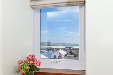 The bedrooms have views across the docks to Mount's Bay.