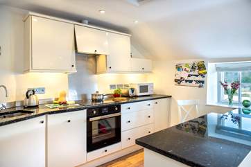 The kitchen has everything you could need, with a little breakfast-bar too.