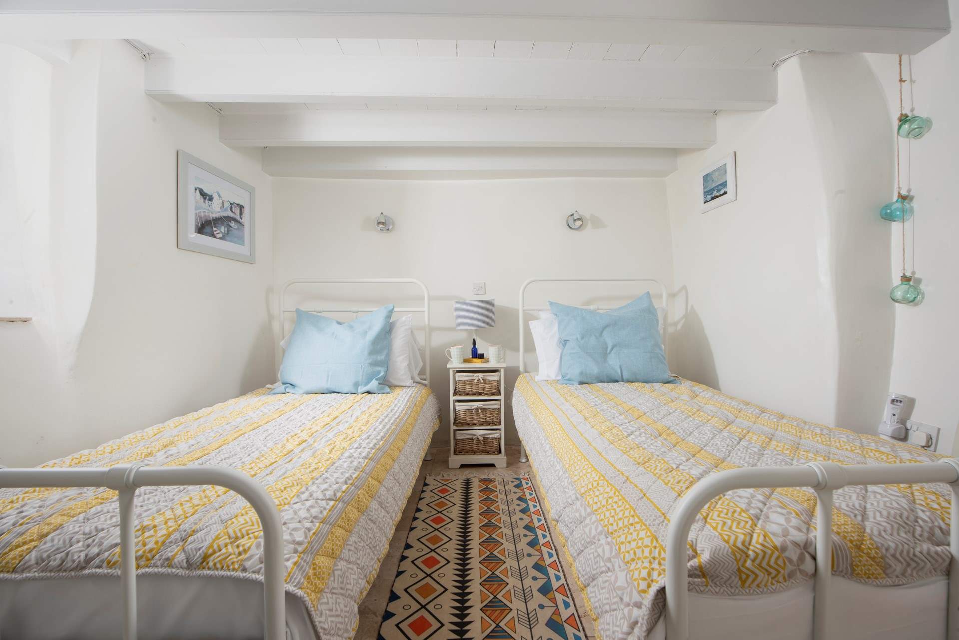 Drift off to the song of the sea in the ground floor twin bedroom.