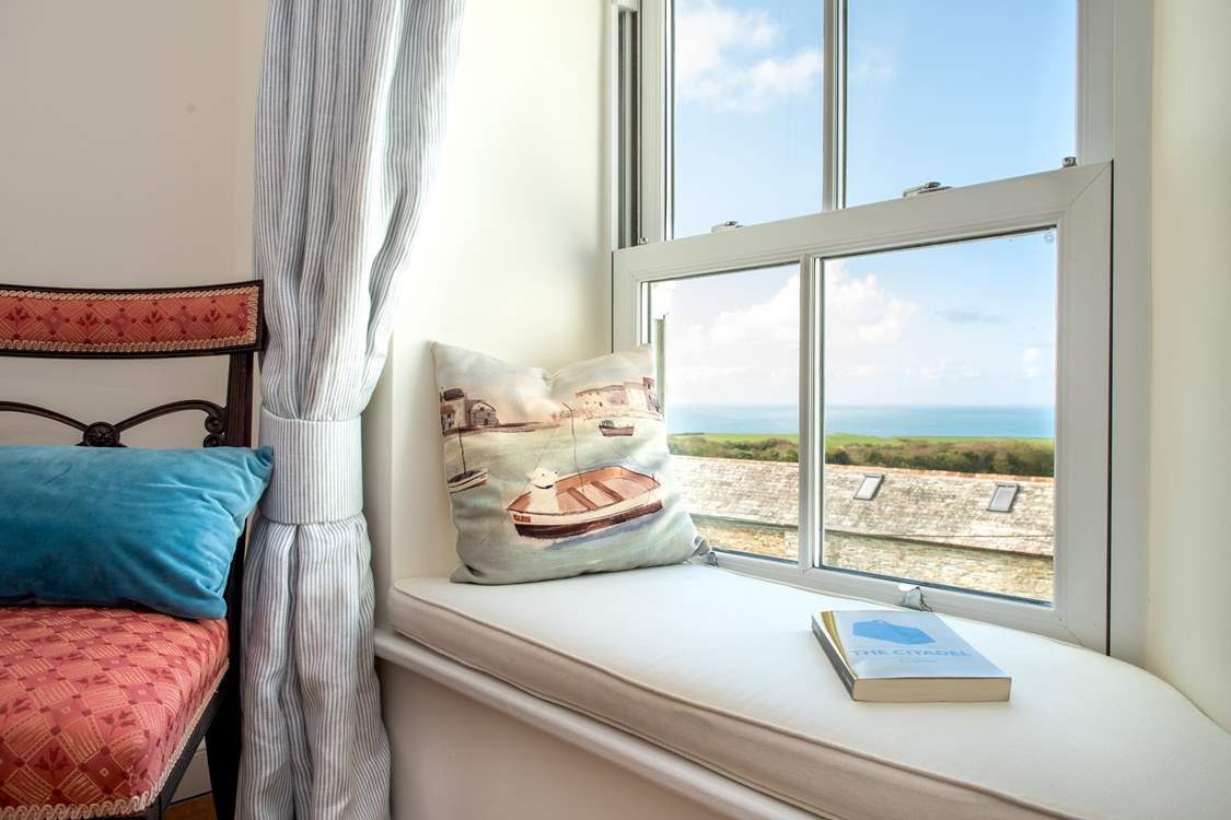 Bedroom 1 enjoys views of the garden, and in the other direction views of the sea.